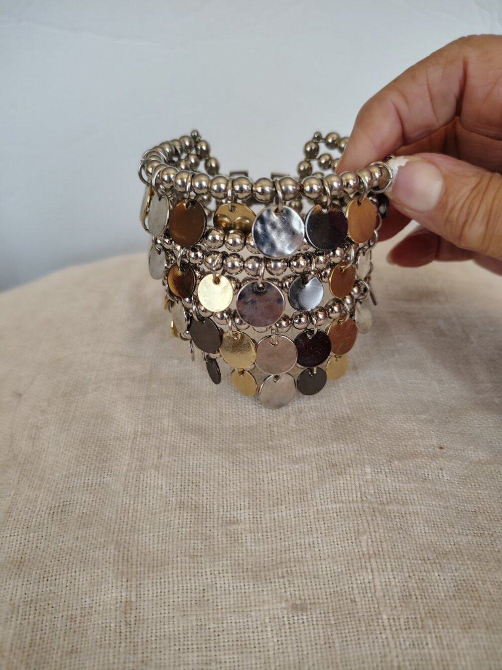 Silver tone multi wired beaded cuff bracelet with multi dangling discs